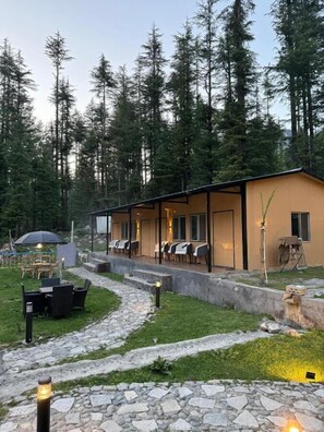 A lodge with outdoor seating and a stone pathway leading to the entrance. - Infinity Villa and Resort Kumrat Valley (Kumrat Valley)