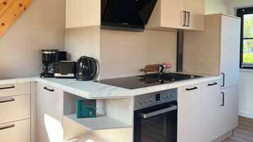 Fridge, stovetop, dishwasher, coffee/tea maker