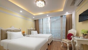 A hotel room with two beds, a desk, a chair, and a television. - Hanoi Oldtown Boutique Hotel  (Hanoi)