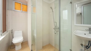 A modern bathroom with a glass-enclosed shower, a white sink, and a toilet. - Hanoi Oldtown Boutique Hotel  (Hanoi)