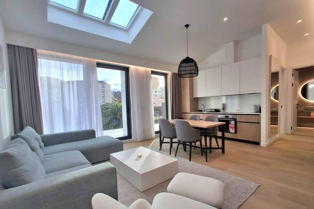 A modern apartment with a living area, dining space, and kitchen.