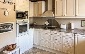 Fridge, stovetop, dishwasher, coffee/tea maker