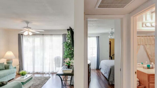 A modern hotel room with a living area, a dining space, and a bedroom. - Charming Coastal Escape (Melbourne)