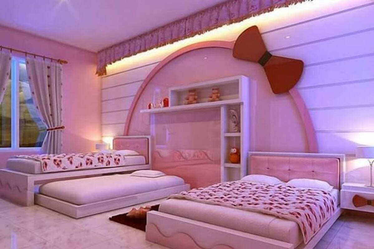 A bedroom with two beds, a built-in wardrobe, and a large window with curtains.