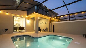 An indoor swimming pool with a glass ceiling, string lights, and a view of the interior. - Storey Lake Resort, Private Pool, Near Famous Attractions!! (Kissimmee)