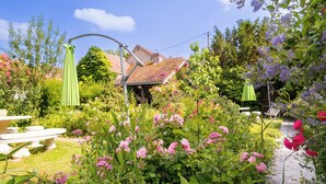 A garden with a gazebo, a brick house, and a paved path. - Aux Charmes de Maintenon - Adults Only (Maintenon)