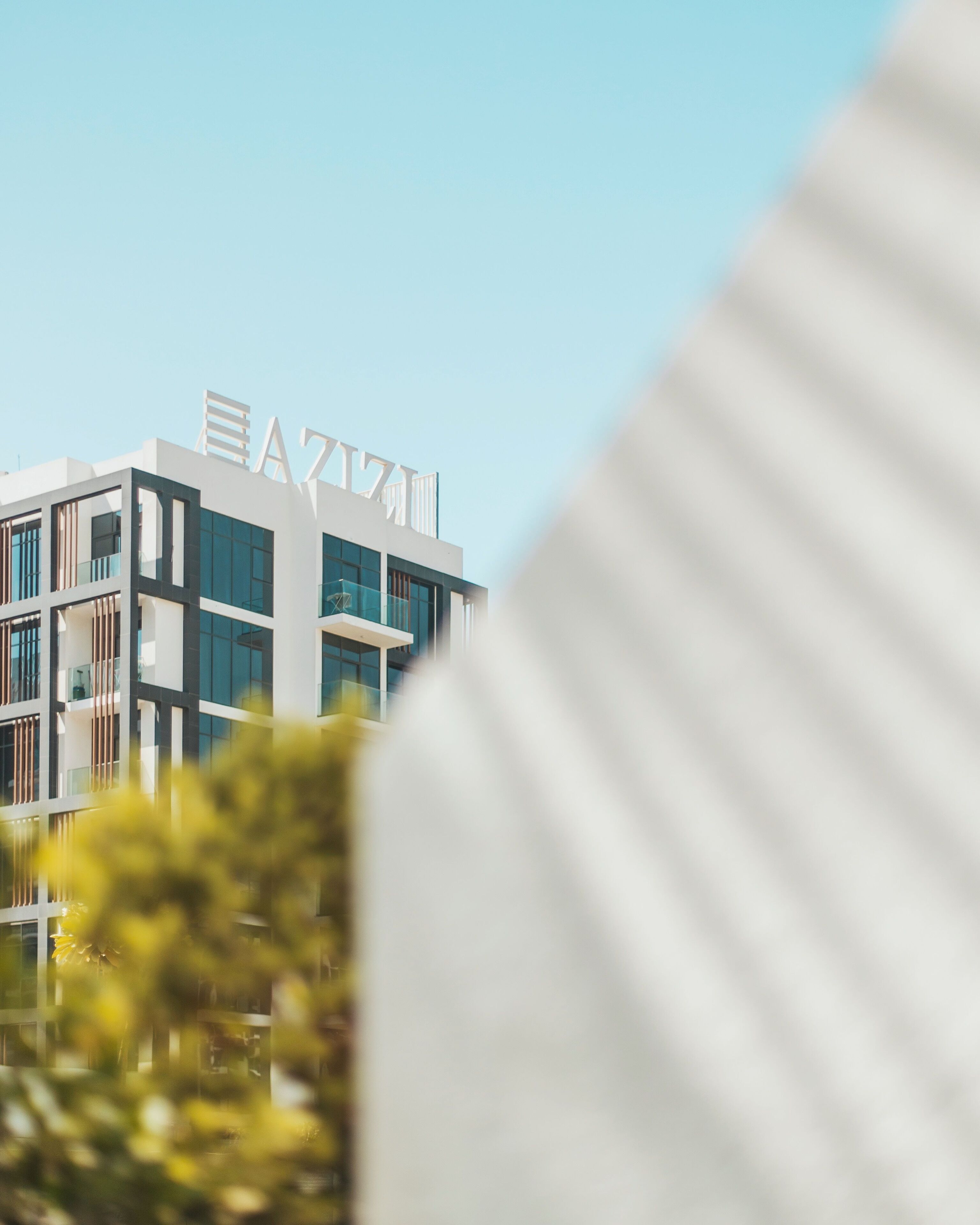 A modern building with a prominent sign reading "EAZZA".