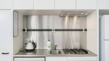 A modern kitchen with stainless steel appliances, a dishwasher, and a built-in oven.