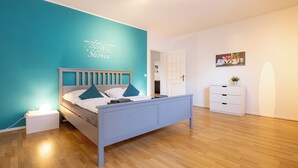 A bedroom with a bed, bedside table, and a nightstand.