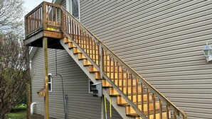 A wooden staircase leading to a deck attached to a house with siding. - Charming pet friendly 1-bedroom apartment with WiFi, AC in quaint Conneaut Lake (Conneaut Lake)