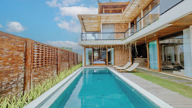 A modern house with a swimming pool, a wooden deck, and a glass conservatory. - D'Kamboja KIS1 Managed by D'Kamboja Group (Bali)