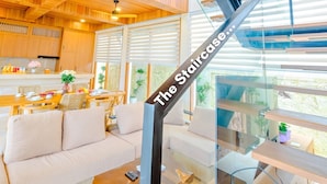A modern interior with a staircase labeled "The Staircase" leading to an upper level. - D'Kamboja KIS1 Managed by D'Kamboja Group (Bali)