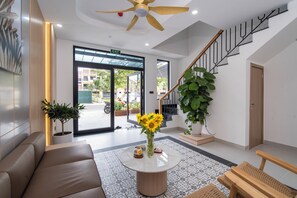 Luxury apartment | Living area | 40-inch flat-screen TV with cable channels - Nam Hoi An Riverside Hotel (Da Nang)