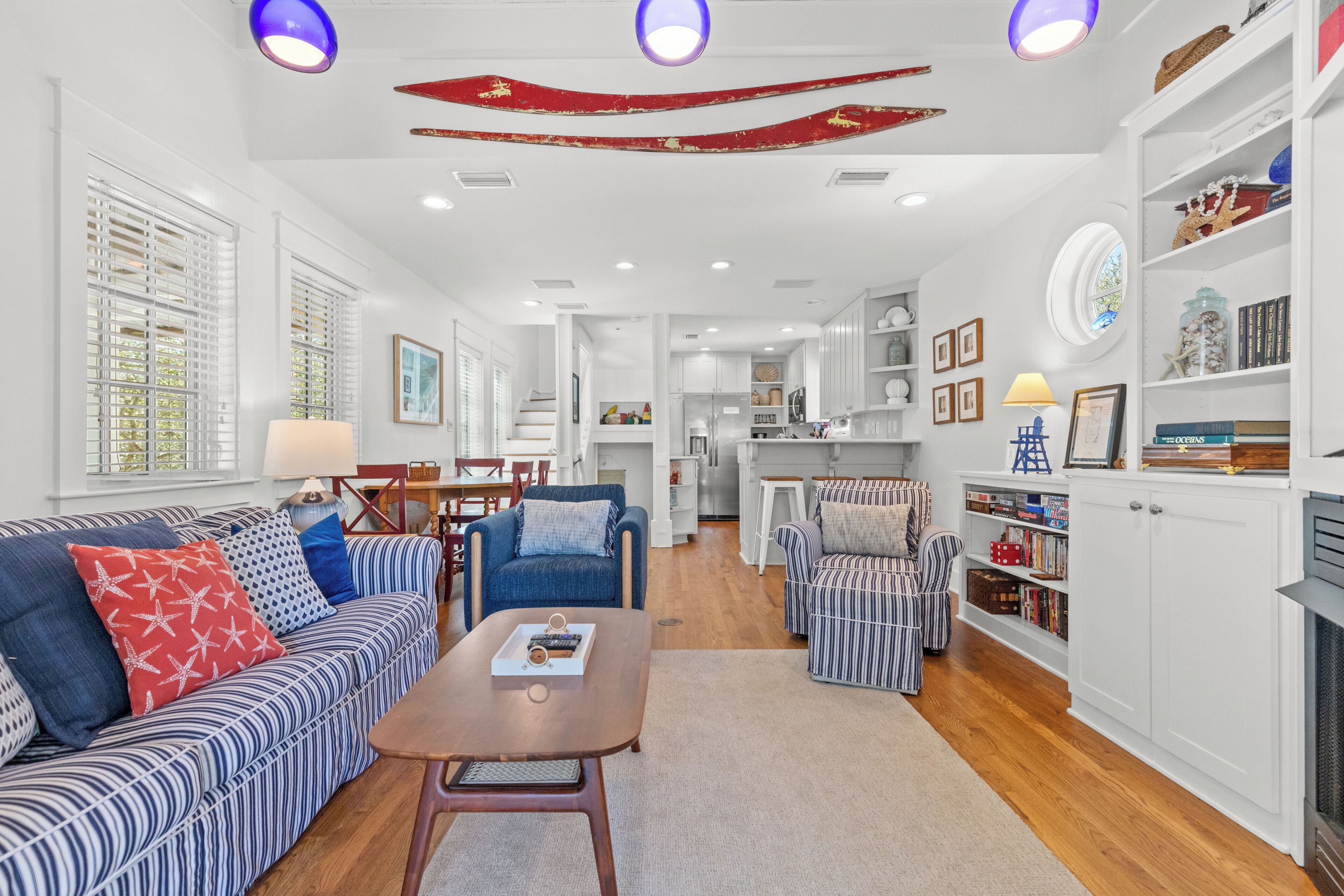 A spacious living room with a sofa, armchairs, a coffee table, and a fireplace.