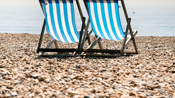 Two striped beach chairs on a pebbled beach with a calm sea in the background. - Brighton High Road Beach Studio (Brighton and Hove)