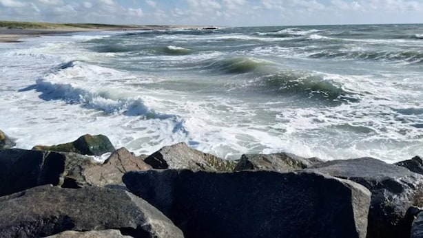 A rocky shoreline with waves crashing against the rocks. - 6 Person Holiday Home in Skaerbaek (Skaerbaek)