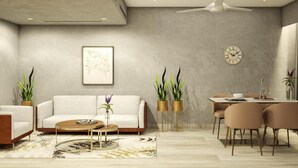 A modern living room with a sofa, coffee table, and dining area. - Trunk & Trolley A Luxury Boutique Hotel  (Hyderabad)