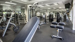 A gym with various exercise equipment, including weight machines and free weights.