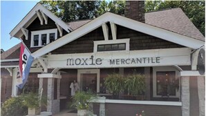 A building with a sign reading "moxie MERCANTILE" and a flag with "moxie" on it.