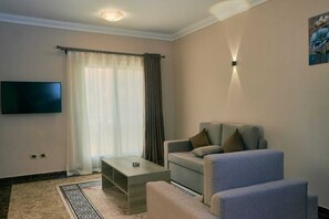 Deluxe kamer, balkon | Woonruimte