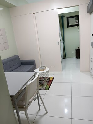 Living area - 1-bedroom apartment with WiFi, AC,Netflix,resto,cafe,transpo near the area. (Manila)
