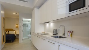 A modern kitchen with a microwave, sink, and a toaster.