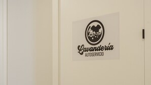 A white door with a logo and text reading "Lavanderia Autoservicio". - BAHIA Suite -apart. adaptado- (Cádiz)