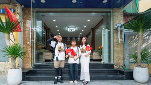 The exterior of Mai Luxury Hotel with a clear entrance, a signboard displaying the hotel's name and address, and a visible flag. - MAI Luxury Hotel Ninh Binh (Ninh Binh)