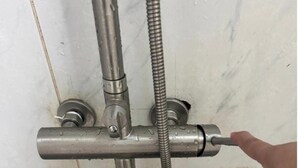 Douche met een hendel om de watertemperatuur te regelen, wat aangeeft dat er warm water beschikbaar is.