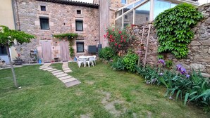 A stone building with a garden, outdoor seating, and climbing plants. - Welcome to the "Lydmalida" gîte, the Ardèche is waiting to welcome you! (Les Ollières-sur-Eyrieux)