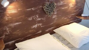 A bed with a wooden headboard, two white pillows, and a bamboo-patterned mattress cover. - Welcome to the "Lydmalida" gîte, the Ardèche is waiting to welcome you! (Les Ollières-sur-Eyrieux)