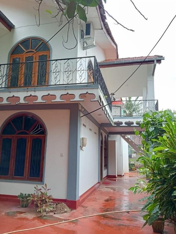 A two-story house with a balcony, large windows, and a red-tiled roof. - Sobia Villa (Jaffna)