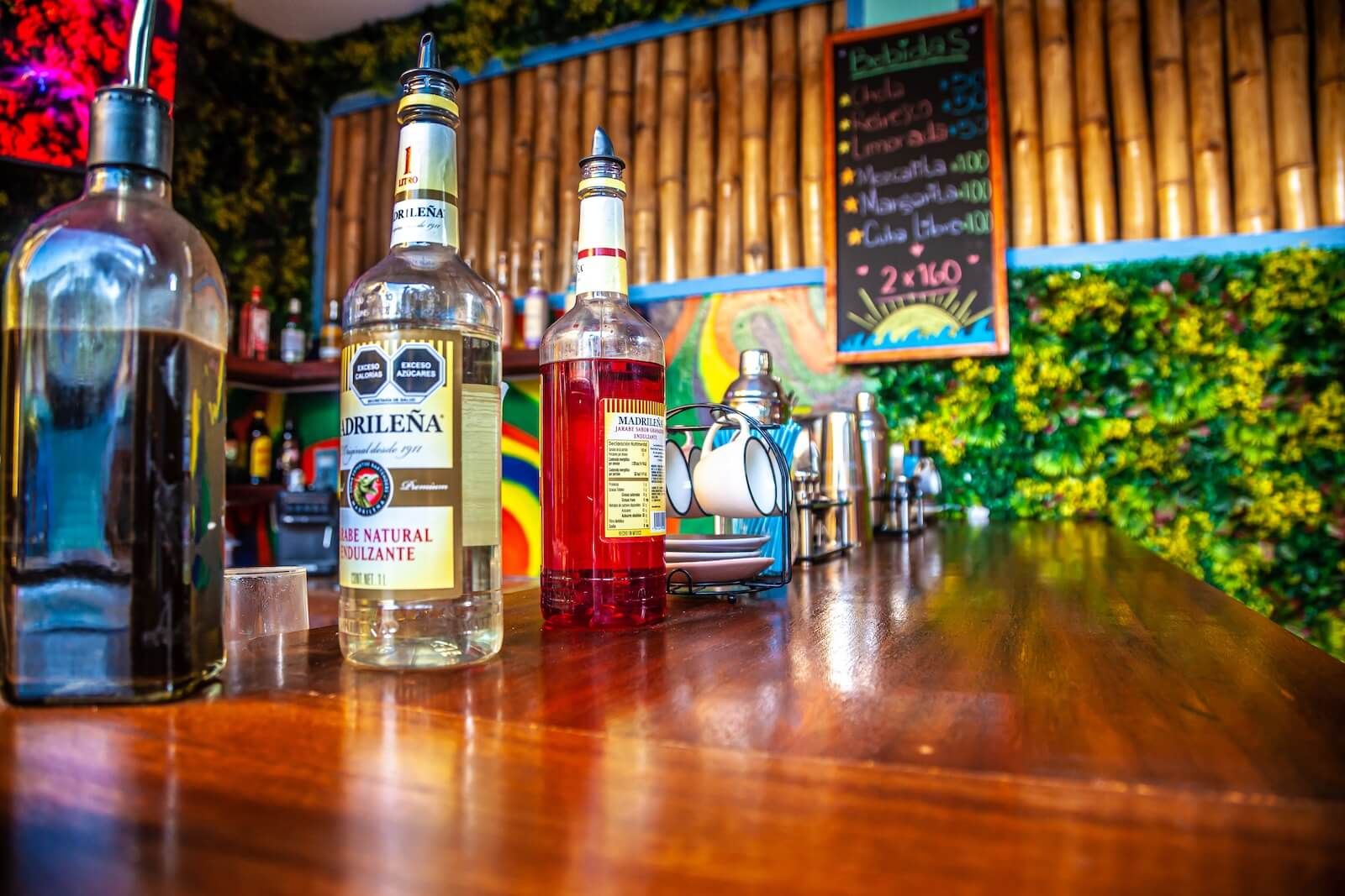 A bar with bottles of liquor and a chalkboard menu.