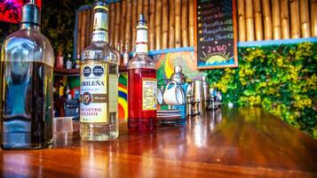 A bar with bottles of liquor and a chalkboard menu.