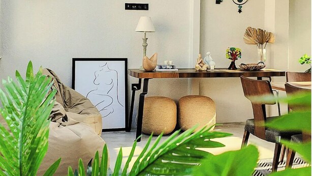 A modern interior with a skylight, a dining area, and a seating space with a plant. - NisUrla (Urla)