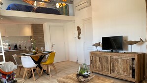 A modern living space with a dining area, kitchen, and a loft bedroom. - Old Antibes, 2 pcs sea view, air conditioning, beach 2min, restaurants, market (Antibes)