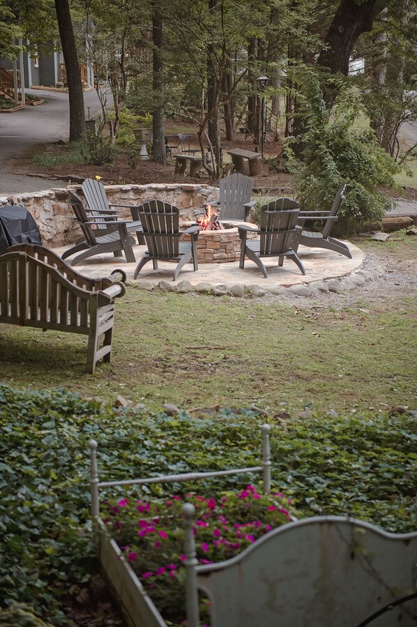 A patio area with Adirondack chairs and a fire pit.