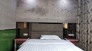 A hotel room with a bed, nightstands, a wall mural, and a patterned wall. - Xinhao Fashion Hotel (Shanghai)