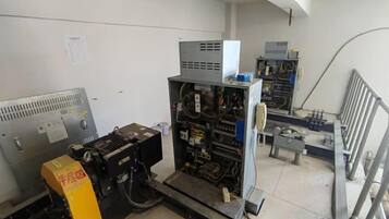 A technical room with various electronic equipment and machinery.