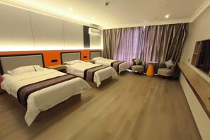 A hotel room with three beds, a TV, a desk, and a chair. - Erenhot Jingtai Hotel (Erenhot)