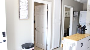 A kitchen with a wooden countertop, a trash bin, and a door leading to another room. - Brand new 2-bedroom in charming Santa Maria with WiFi, AC (Santa Maria)