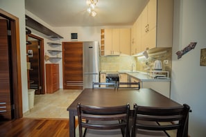 Enjoy cooking in this well-equipped kitchen with a central island, stainless steel appliances, and ample cabinetry.