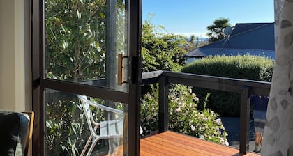 Walking distance to central Nelson, a sun-drenched cottage with views to the sea