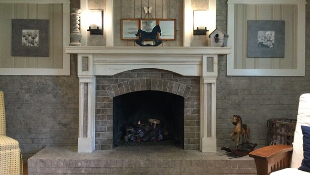 A fireplace with a mantel decorated with framed pictures and a small sculpture. - Charming 3-bedroom house in lovely Rome with WiFi, AC (Rome)