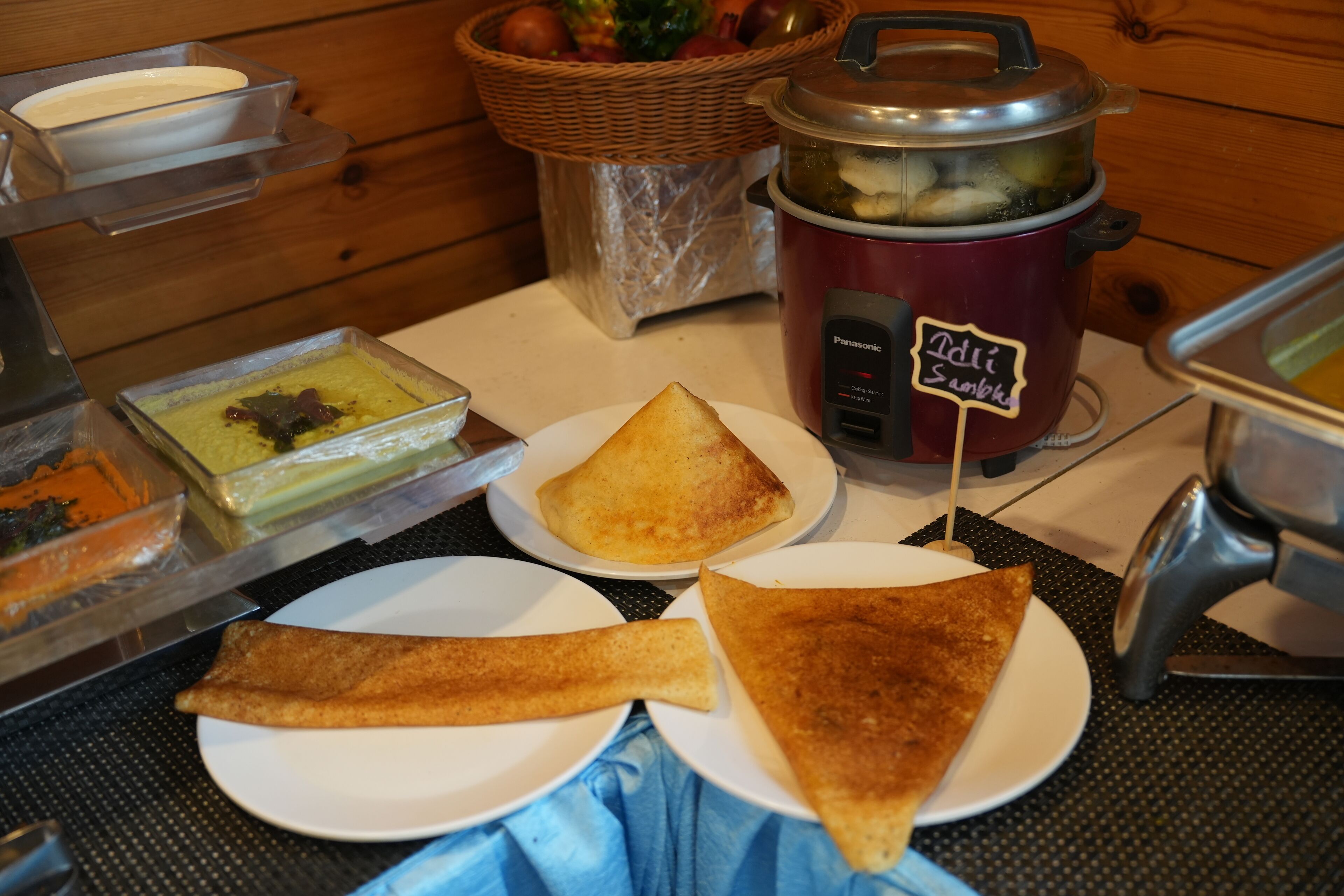 A breakfast buffet with various dishes, including pancakes and a slow cooker labeled "Deli Soup".