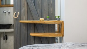 A wooden shelf with a rope handle, two small potted plants, and a rustic door in the background. - Semi-basement 'Deluxe Suite' Room with Wi-Fi and Air Conditioning (Naxos)