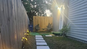 A pathway with white steps leading to a wooden fence. - Cozy Private Tiny Guest House (Jacksonville)