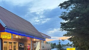 A building with a 'FICE' sign, a staircase, and a parking area. - Athabasca Hillside Motel (Athabasca)