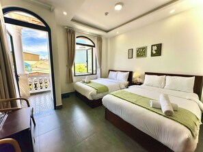 A hotel room with two beds, a balcony, and a view of buildings. - Amelia House - Boutique Hotel (Lam Vien - Da Lat)