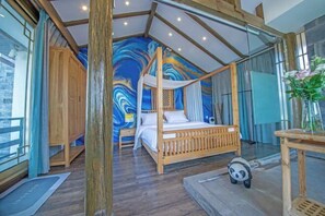 Cozy retreat with a sloped ceiling, wooden beams, and a vibrant mural.